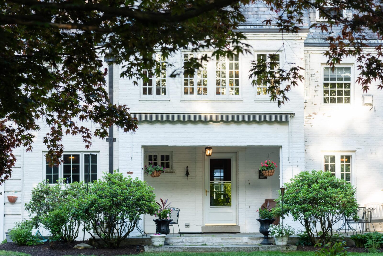 exterior of white brick manor home- The Inn on Putney Road