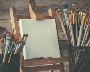 Artistic Equipment: Empty Artist Canvas On Easel And Paint Brush