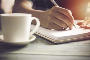 writers with paper and coffee cup