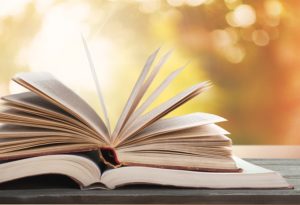 writers books stacked outdoors