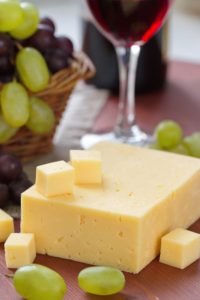 Cheese fresh grape and red wine in glass