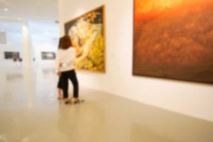 Blurred image of two people admiring paintings at the Brattleboro Museum and Art Center