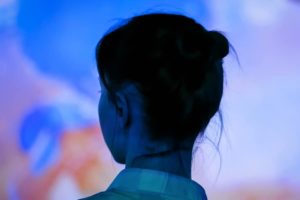 Back view of woman looking at an interactive exhibit at the Brattleboro Museum and Art Center