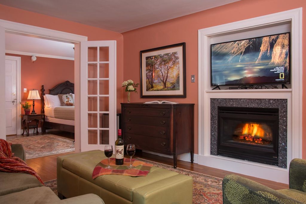 A cozy fireplace in the sitting room of our guest room, a great place to relax, unwind, and enjoy the beauty of Vermont in the fall