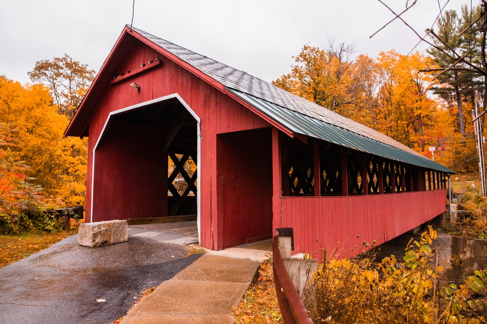 A beautiful covered bridge with fall foliage near Brattleboro, one of the best places to stay in Vermont