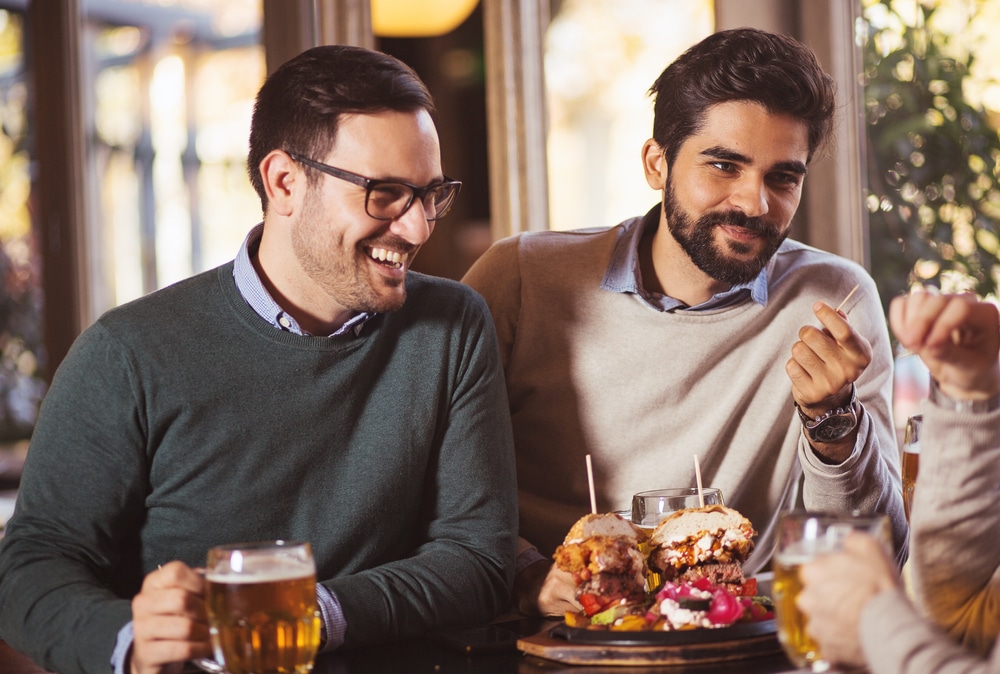 Handsome gay couple enjoying a meal at the top Brattleboro Restaurants while staying at our Bed and Breakfast