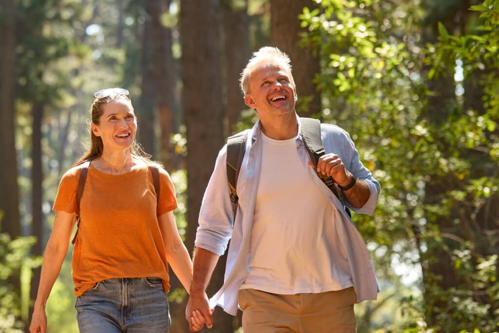 Couple hiking in Pisgah State Park on a beautiful sunny day.