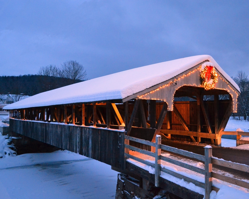 After skiing at Mount Snow, Vermont, enjoy all the other things to do in Vermont in winter, like visiting gorgeous covered bridges covered in snow, shown here.