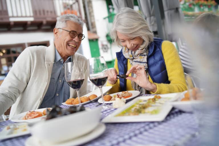 An older couple enjoys a meal at one of the most romantic restaurants in Brattleboro, VT.