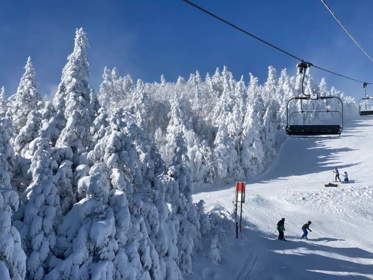 Ski slope and chair lift on sunny day at Mount Snow Ski Resort.